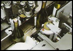 Bottle trap for front and back bottle labeler